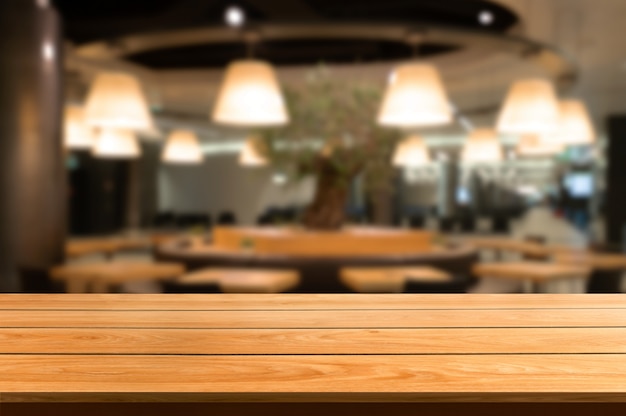 Wood table in blur background of modern restaurant