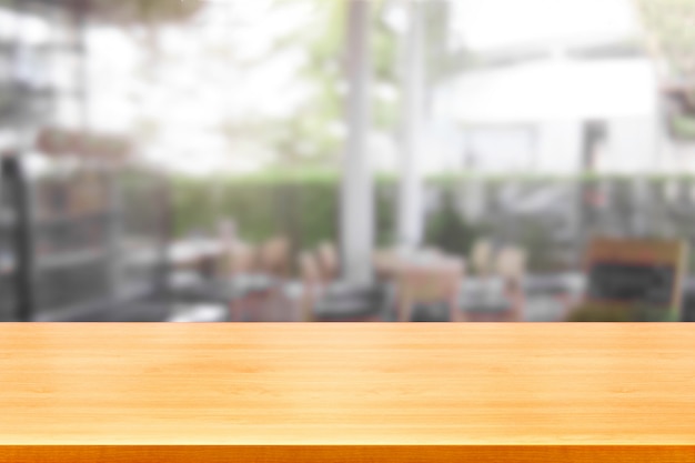 Wood table in blur background of modern restaurant