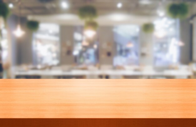 Wood table in blur background of modern restaurant