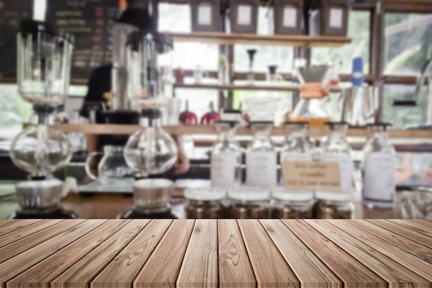 wood table in blur coffee shop