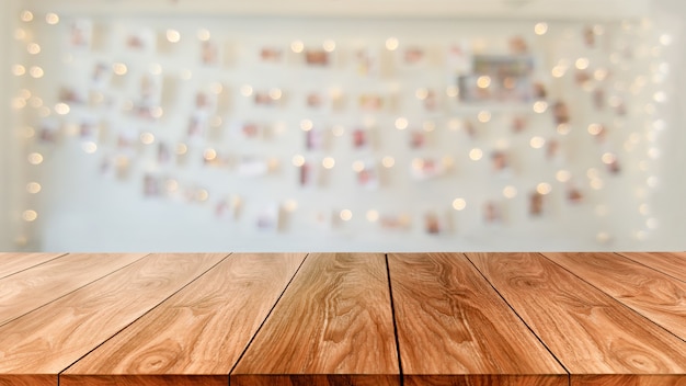 wood table in blurry background of modern restaurant room or coffee shop for product display mockup.