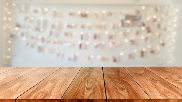 Wood table in blurry background of modern restaurant room or coffee shop for product display mockup.