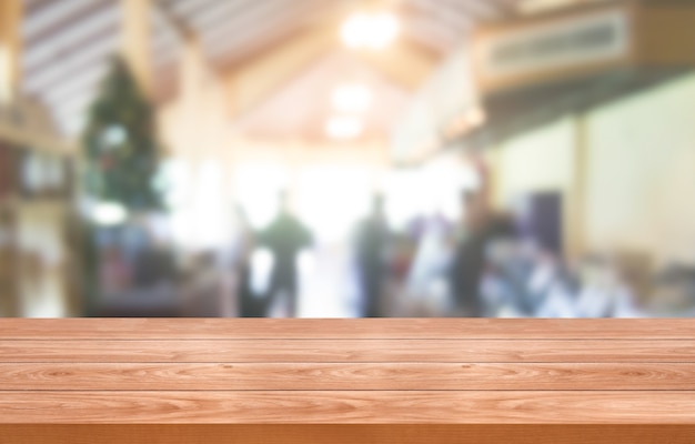 Wood table in blurry background of modern restaurant room or coffee shop for product display