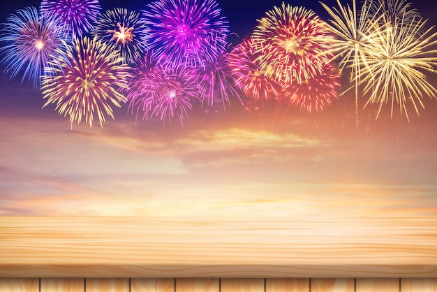 Wood table floor and Amazing Beautiful firework on sky clouds background for celebration anniversary merry christmas eve and happy new year.