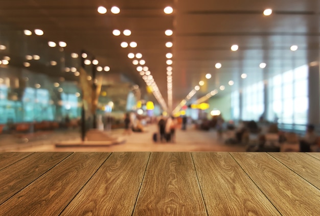 Wood table in large conference hall background.