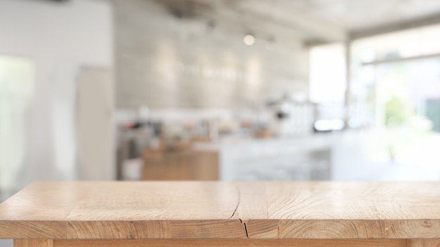 Wood table for product display montage in blurred cafe 