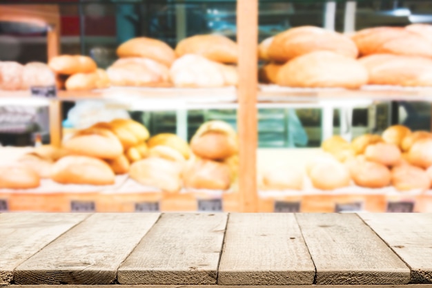 Wood table top on bakery shop background.