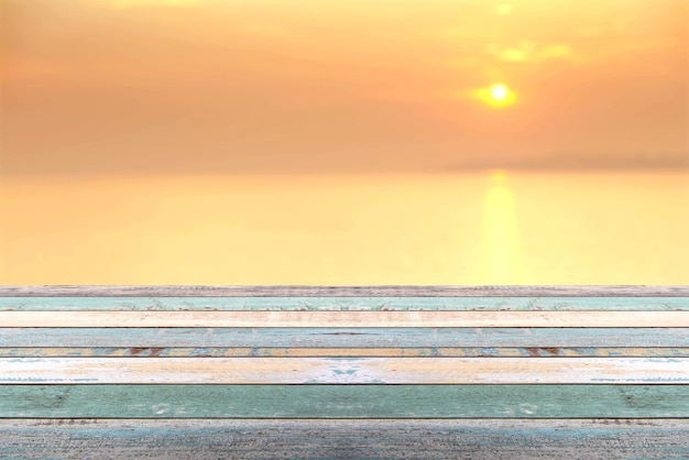 Wood table top on blur background of Beautiful sunset on the sea at twilight times, vintage tone - can be used for display or montage your products