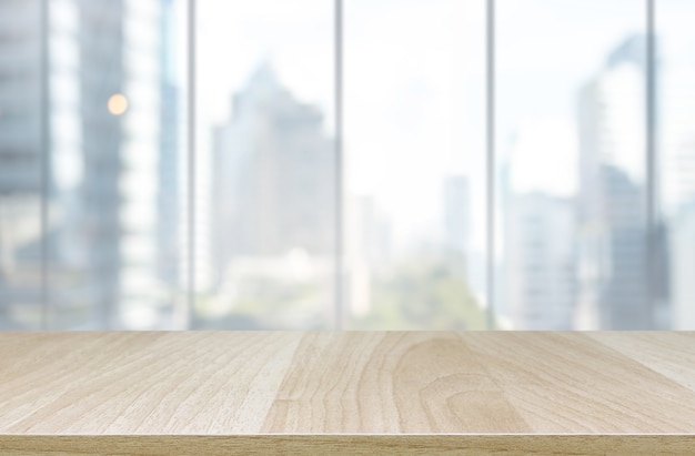 Wood table top and blur glass window wall building background - can used for display or montage your products.