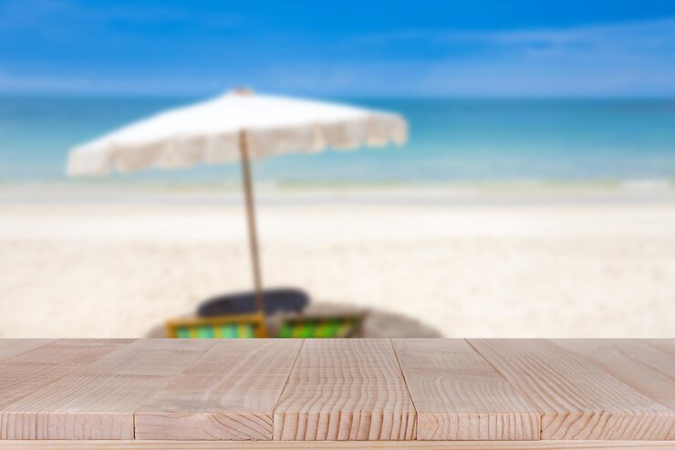 Photo wood table top on blurred blue sea and white sand beach background
