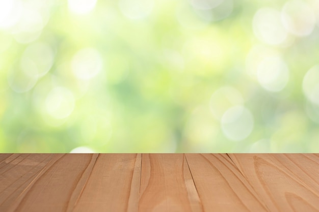 Wood table top on blurred greenery background in garden for montage your products.