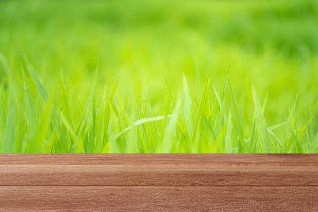 Wood table top on blurred greenery background in garden for montage your products