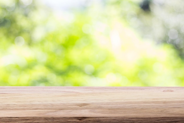 Wood table top on bokeh green bright background For montage product display or design key visual layout