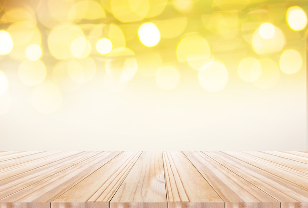 Wood table top on disfocus of light bulb