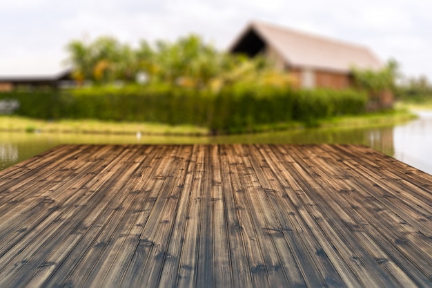 Wood table top isolated on blur house in the country background