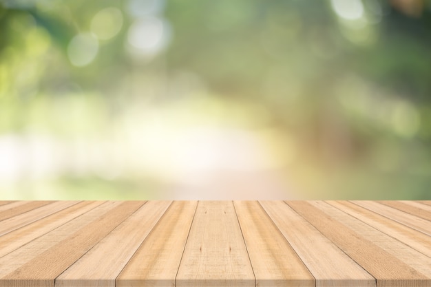 Photo wood table top on nature green blurred background,for montage your products