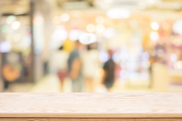 wood table top on shoppingmall blurred background,Space available for the product