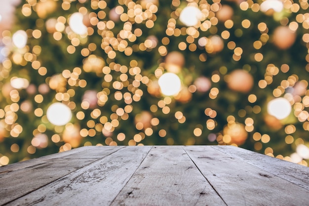 Wood table top with abstract christmas holiday festive bokeh light on tree blurred background for montage product display