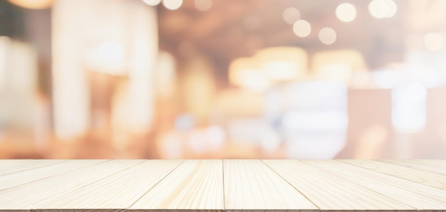 Wood table top with restaurant cafe or coffee shop interior
abstract defocused blur background