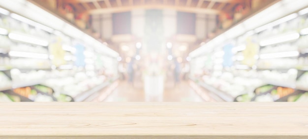 Wood table top with supermarket grocery store blurred background with bokeh light product display