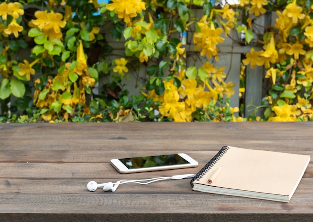 wood table with beautiful yellow flowers background