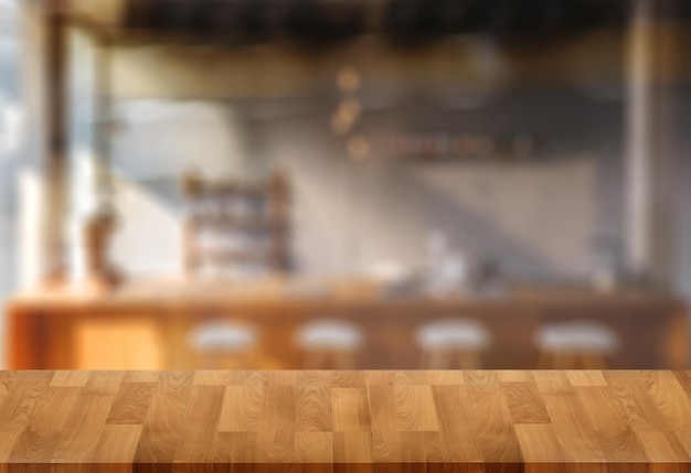 Wood table with blur in coffee shop cafe For montage product display table copy space cafe background with copy space for text