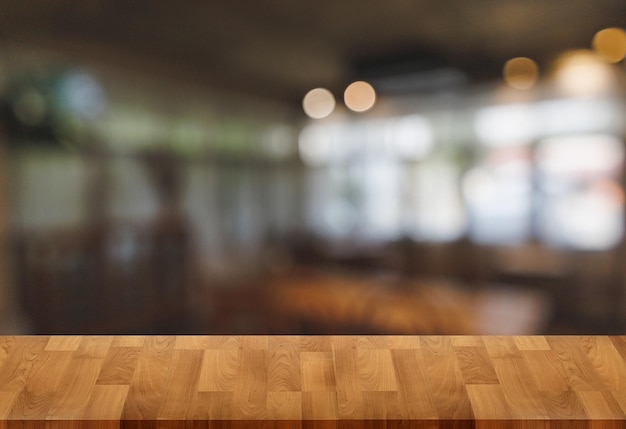 Wood table with blur in coffee shop cafe for montage product
display table copy space cafe background with copy space for
text