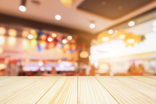 Wood table with Restaurant cafe coffee shop interior with people abstract defocused blur background