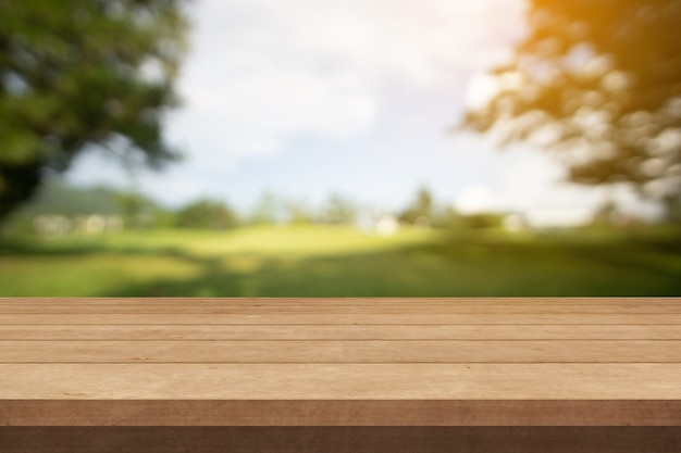 Wood table or wood terrace and green garden in summer sun