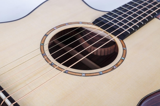 Photo wood texture of lower deck of six strings acoustic guitar on white background guitar shape