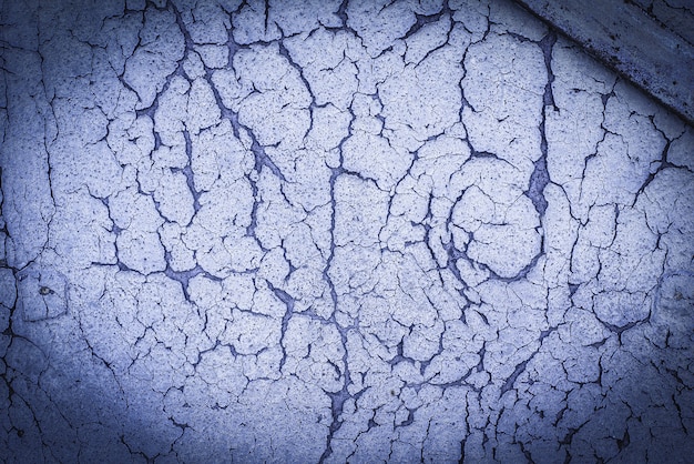 Wood texture with blue, purple, lilac flaked paint. Peeling, weathered. Old cracked paint on rusty background