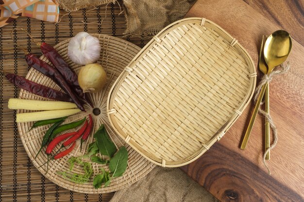 Wood tray with Thai herbs and spoon and fork with free space for text background