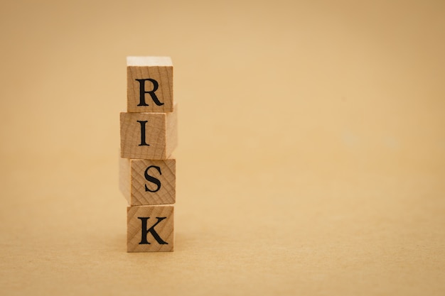 Wood word RISK using as background business concept and Risk concept 