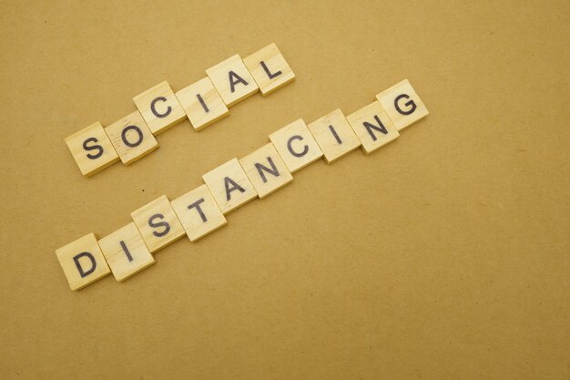 wood word social distancing stay apart to reduce covid 19 virus infection. maintain social distance