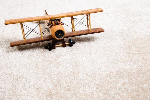 wooden airplane on the carpet