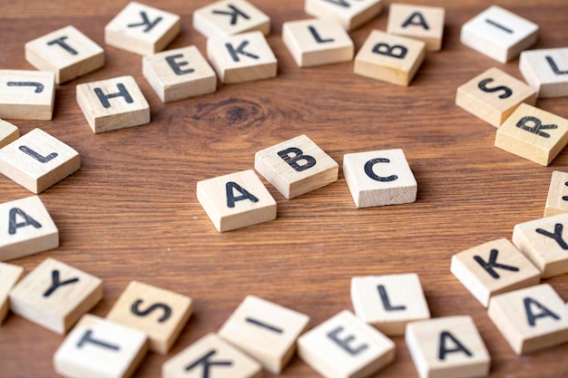 Wooden alphabet on the wooden table