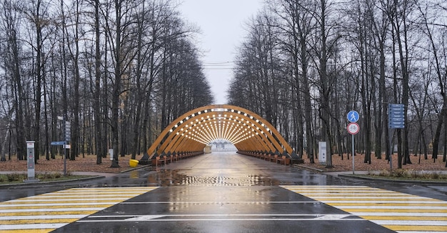 wooden arch in the evening autumn park hung with lamps