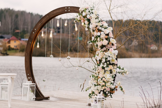 Wooden arch for wedding ceremony with beautiful flowers