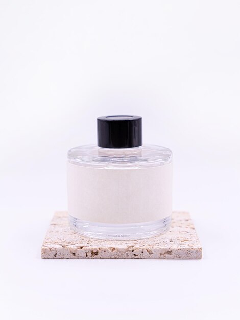 wooden aroma sticks in a glass flask filled with flavor liquid substance isolated over white background side view