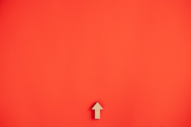 Photo wooden arrows point on red background space for your text