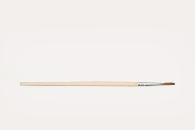 Wooden artistic paintbrush on a white background with copy space