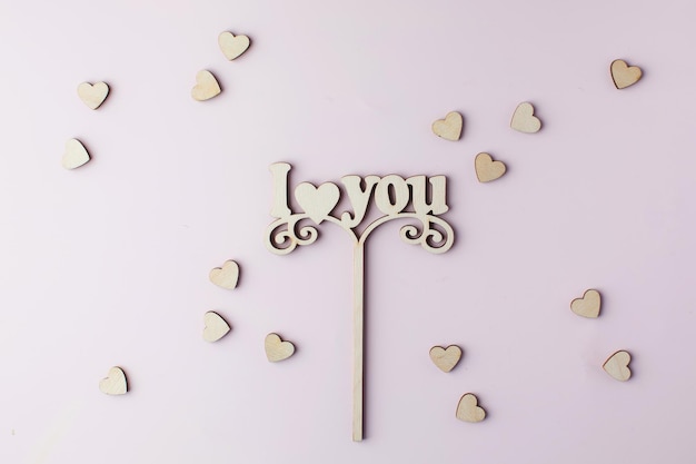 A wooden axe with the words I LOVE YOU on a pink background