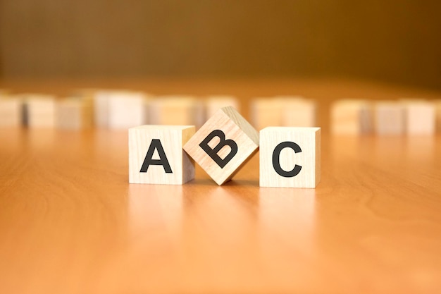 On a wooden background light wooden blocks with the text ABC