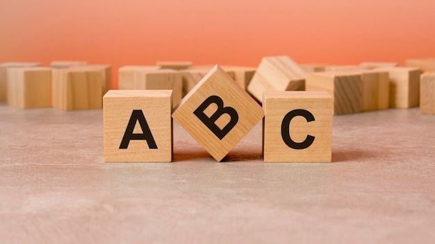 On a wooden background light wooden blocks with the text abc