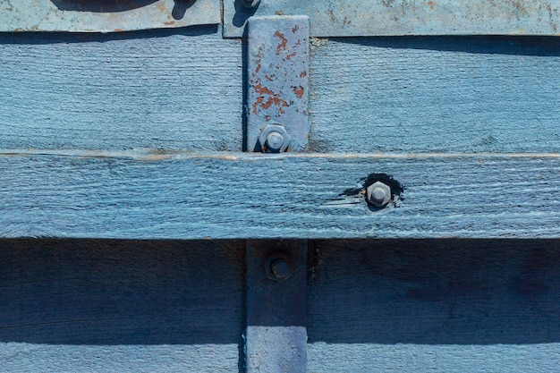 Wooden background old wooden wall painted blue with slits and nails