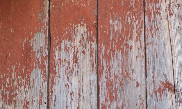 Wooden background the red old paint peeling off