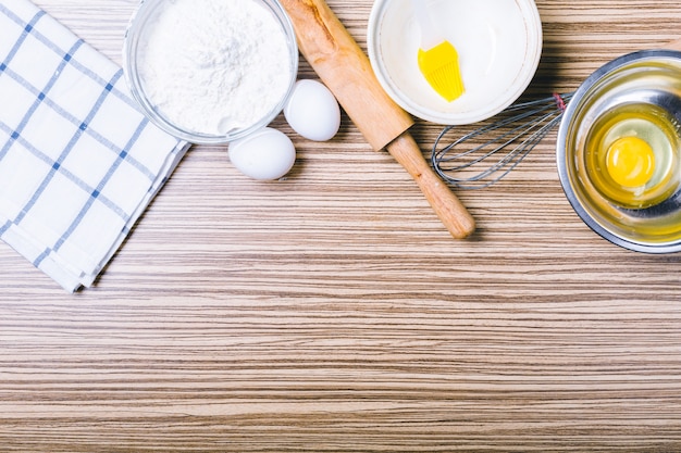 Wooden background with baking ingredients. Top view.