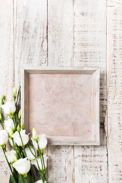 Wooden background with bouquet of white flowers