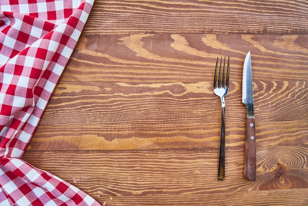 Wooden Background with Plaid Fabric, Fork and Knife