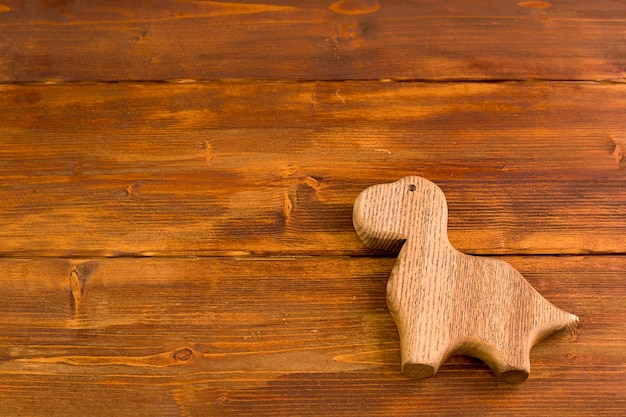 Wooden background  a wooden dinosaur on a wooden surface